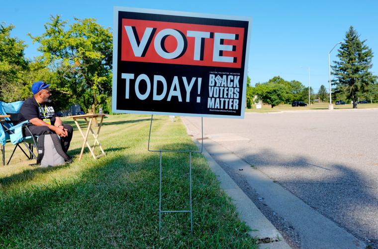 A vote today sign by the Black Voters Matter Fund on display outside of precinct nine and ten at Owen Elementary School in