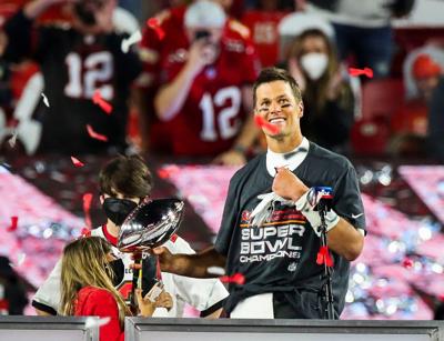 Tampa Bay Buccaneers quarterback Tom Brady celebrates with his family as he hoists the Lombardi trophy after their win over the Chiefs in Super Bowl 55, at Raymond James Stadium.