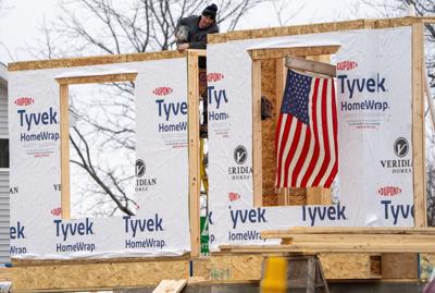 A carpenter works on a home on March 4, 2025 in Waunakee, Wisconsin. President Donald Trump's administration imposed long-awaited 25% tariffs on imports from Canada and Mexico, a move that's expected to increase prices for consumers on a slew of everyday p