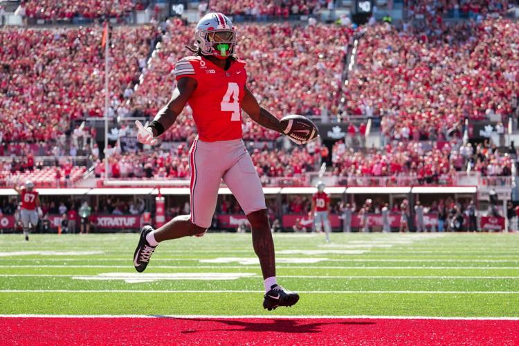 Ohio State Buckeyes wide receiver Jeremiah Smith (4) scores a touchdown during the NCAA football game against the Illinois