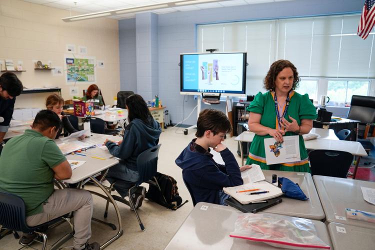 Alexandria City High School government instructor Amanda Kropp with students at Alexandria City High School. Experts widely believe improved civics courses could be an anecdote for our partisan divisions. Yet, teachers say the realities in the classroom ma