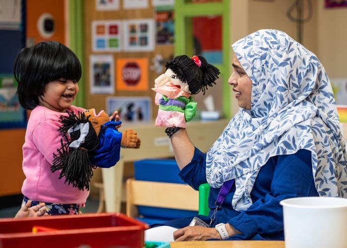 Head Start teachers assistant Zutsnara Rahman, right, uses a puppet with Aliza Ahmed at Mitchell Head Start Center in Hamtramck on Monday, October 5, 2026. In addition to rolling back Head Start program requirements and standards, the Trump administration
