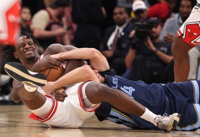 Bulls forward Leonard Miller, left, and Grizzlies guard Cam Spencer get down for a loose ball in the third quarter of a preseason game at the United Center on Oct. 9, 2026, in Chicago.