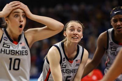 Connecticut's Paige Bueckers and Nika Muhl react after a foul called on teammate Christyn Williams against Arizona during the third quarter in the Final Four semifinal of the NCAA Tournament at the Alamodome on April 2, 2021, in San Antonio, Texas.