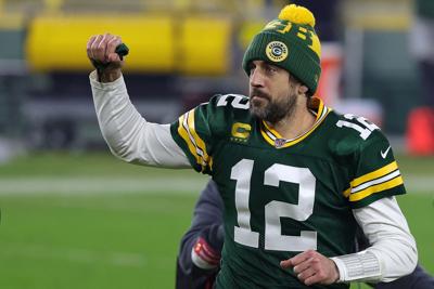 Aaron Rodgers #12 of the Green Bay Packers leaves the field following the NFC Divisional Playoff game against the Los Angeles Rams at Lambeau Field on Jan. 16, 2021 in Green Bay, Wisconsin.