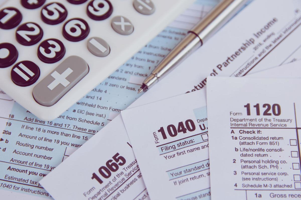 Tax season. calculator, pen on US tax form background