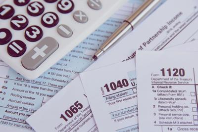 Tax season. calculator, pen on US tax form background