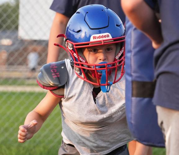 Bryce Avitabile, 7, hits a tackling pad at the Raynham Police Department Juvenile Organization of Cops and Kids (J.O.C.K.S.)