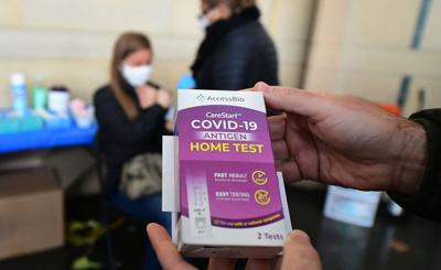 A rapid COVID-19 test kit is displayed after being given out for free to people receiving their COVID-19 vaccines or boosters at Union Station in Los Angeles on Jan. 7, 2022.