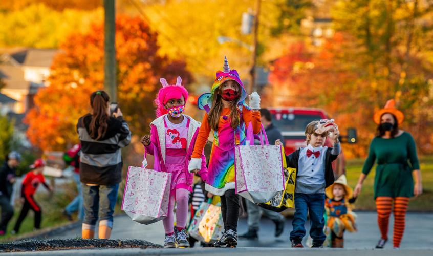 Lilah Gibson, center, Zion Hart, left in pink, Parker Stevens, right in bowtie, and Presley Stevens, right as scarecrow, head up to Monroe Fire Protection District’s Station 22 in 2020 to get some candy and treats from the firefighters. The station at 39