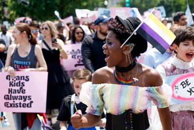 Trans kids and additional activists march to the U.S. Supreme Court following the end of the "Trans Youth Prom" on May 22, 2023, in Washington, D.C. Trans and non-binary youth gathered outside of the U.S. Capitol Building to hold a prom-like event that ...