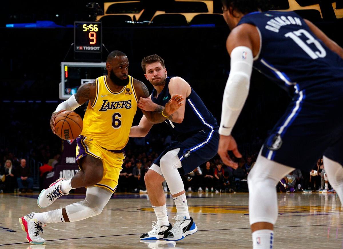 The Los Angeles Lakers' LeBron James drives against the Dallas Mavericks' Luka Doncic in the third quarter at crypto.com Arena on March 1, 2022, in Los Angeles.