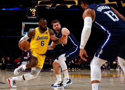The Los Angeles Lakers' LeBron James drives against the Dallas Mavericks' Luka Doncic in the third quarter at crypto.com Arena on March 1, 2022, in Los Angeles.