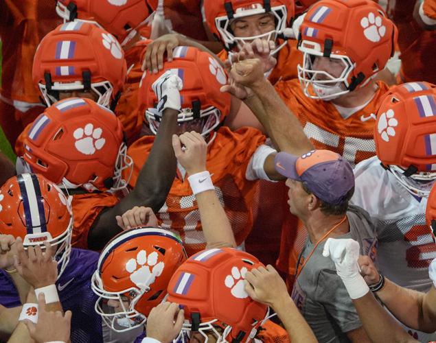 Clemson head coach Dabo Swinney and players huddle during practice in the at the Allen N. Reeves Sports Complex in Clemson, S.C.