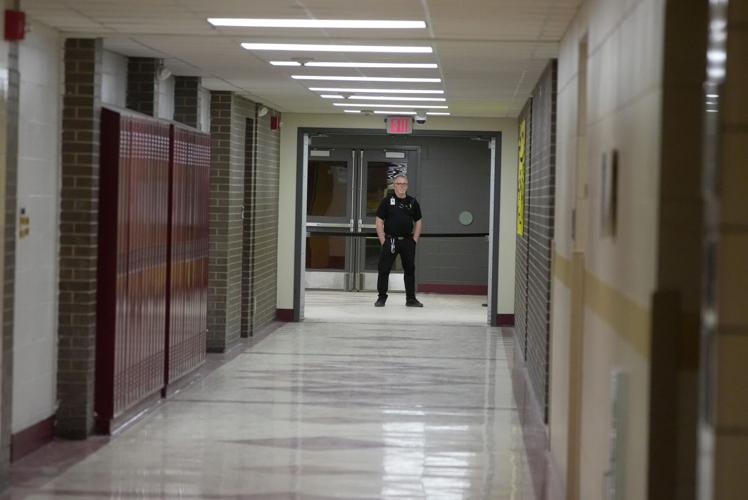 A security guard stands at one entrance of the school to the gym at Greece Athena High School in Rochester, New York, on Feb. 2, 2026.