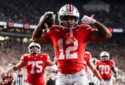 Ohio State Buckeyes running back CJ Donaldson (12) reacts after making it to the endzone during the second half of the NCAA football game against the Ohio State Buckeyes at Ohio Stadium on Sept. 13, 2025. The touchdown was overturned by replay, but Ohio St