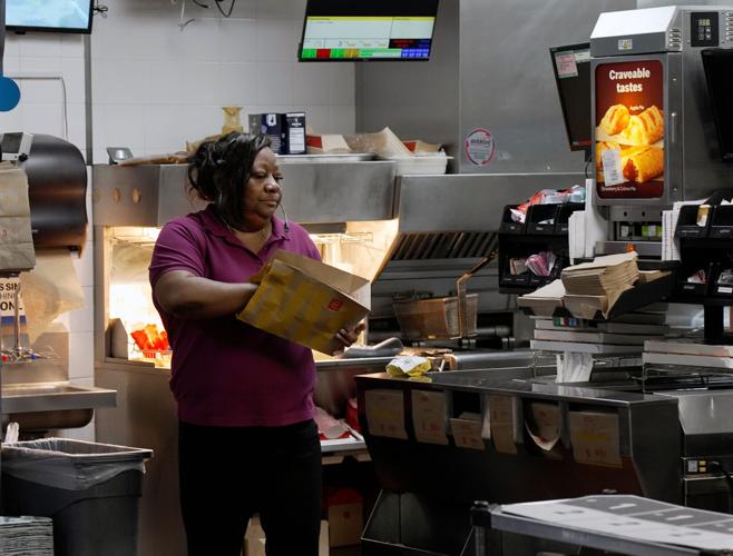 McDonald's store manager and foster parent Donna Neal prepares a food order Tuesday April, 14, 2026, in Hendersonville, Tenn.