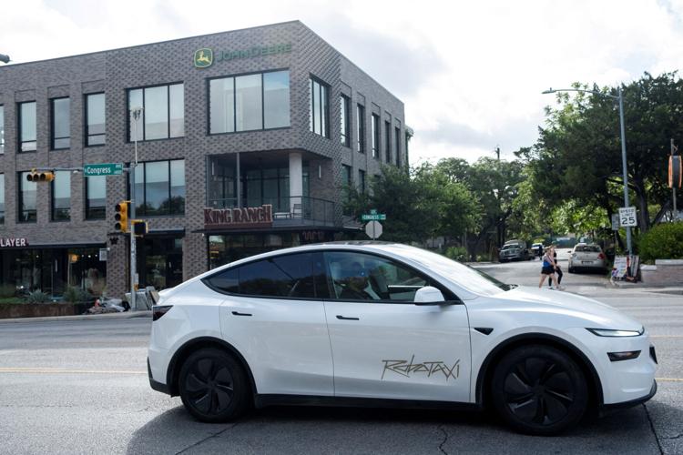 FILE PHOTO: A Tesla robotaxi drives in Austin, Texas