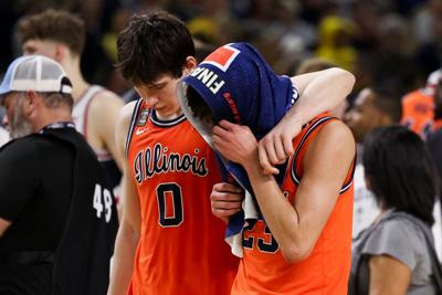 David Mirkovic (0) and Keaton Wagler walk off the court after Illinois' 71-62 loss to UConn