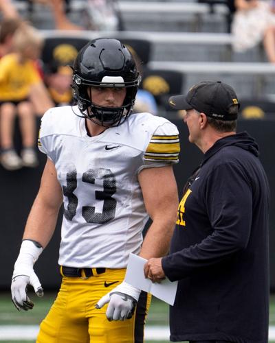 Iowa linebacker Cam Buffington (33) talks to defensive coordinator Phil Parker Aug. 15, 2026 during the Kids Day at Kinnick open