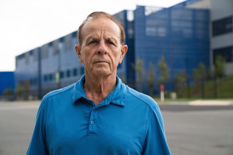 Greg Pirio, a Loudoun County resident, poses for a portrait on Sept. 28, 2026, in front a data center near his home that he said has caused health issues for him and his neighbors. Despite the economic benefits the industry has brought to the region, resid