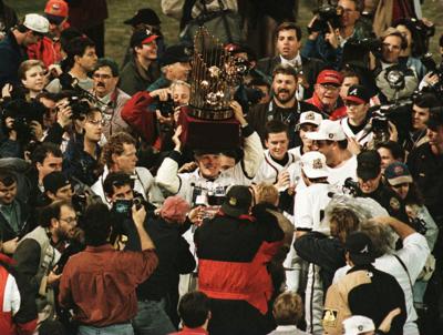 Atlanta Braves owner, Ted Turner, parade the World Series trophy around Fulton County Stadium in Atlanta, Georgia on Oct. 28, 1995, after Atlanta defeated Cleveland 1-0..