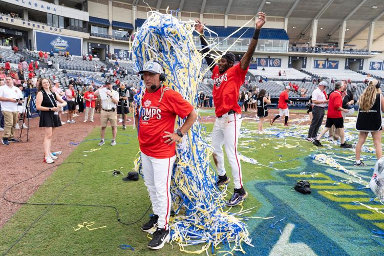 Georgia Bulldog's Tre Phelps (1) tosses confetti as Georgia Bulldogs head coach Wes Johnson is interviewed as Georgia Bulldogs