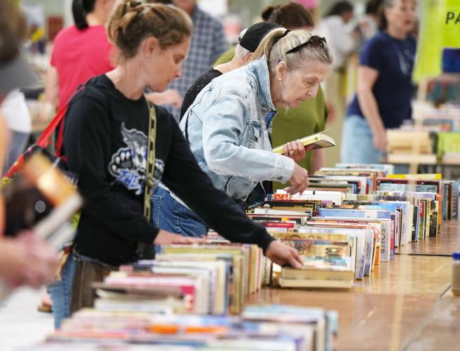 Shoppers look for book bargains during the Great American Book Sale inside the Flo Fabrizio Ice Center in Erie, Pa., on June 14, 2026.