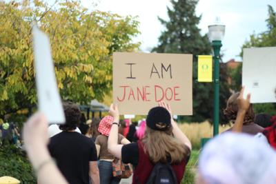 Protesters waved signs saying 'I am Jane Doe' while marching through University of Oregon to protest sexual assault on Oct. 4,