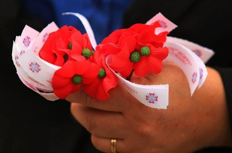 Poppies are handed out during a Memorial Day ceremony in Creswell, Oregon.