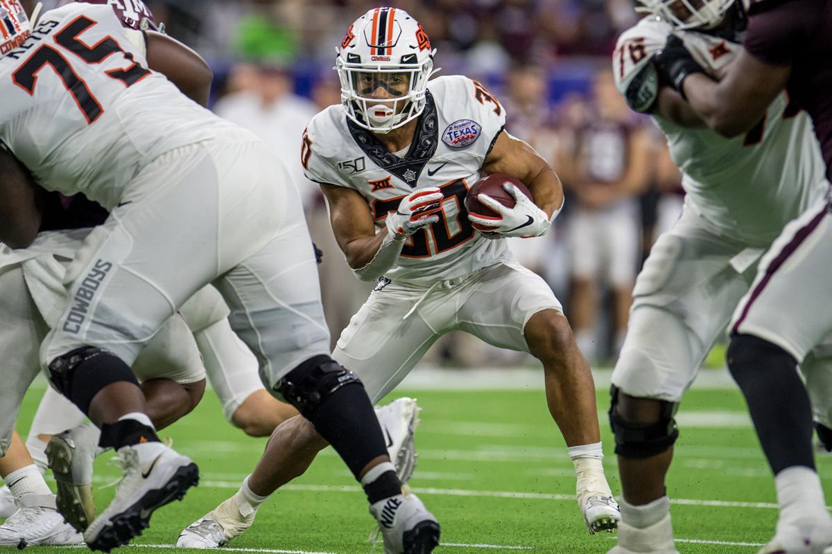 Oklahoma State Cowboys running back Chuba Hubbard (30) carries the ball during the fourth quarter of the Texas Bowl against the Texas A&M Aggies on Dec. 27, 2019 at NRG Stadium in Houston, Texas.