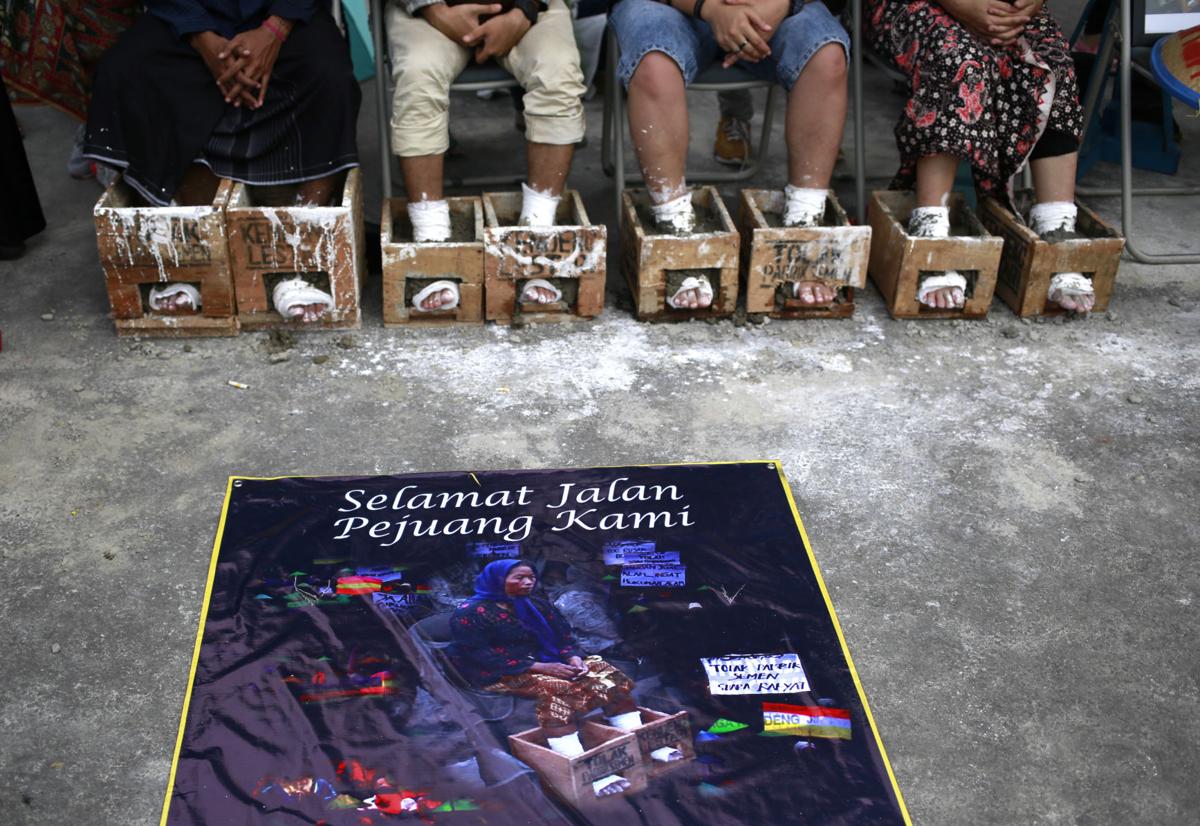 Photos: Indonesian farmers cement feet to protest factory | World