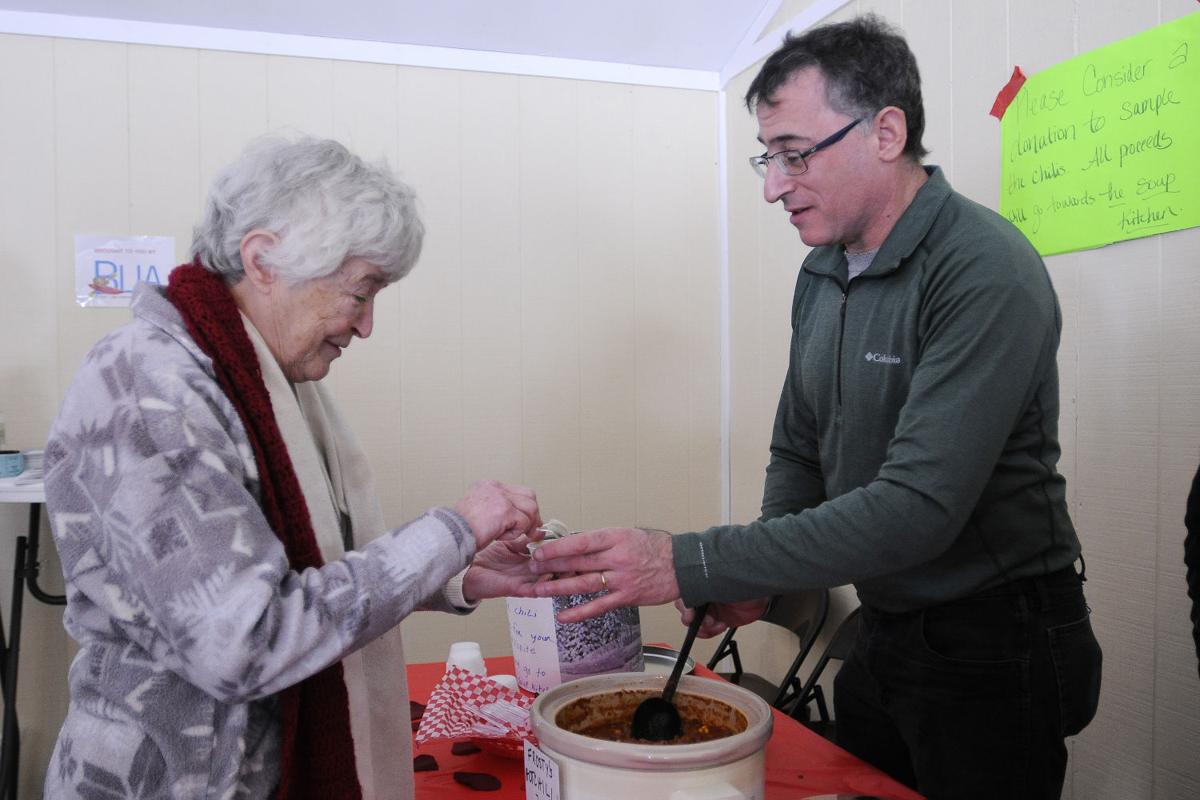 Margaret Ives, of Derry receives a sample of chili from Eric Frank board member of Beaver Lake Association during the 17th annual Frost Festival activities at Alexander Carr Park.