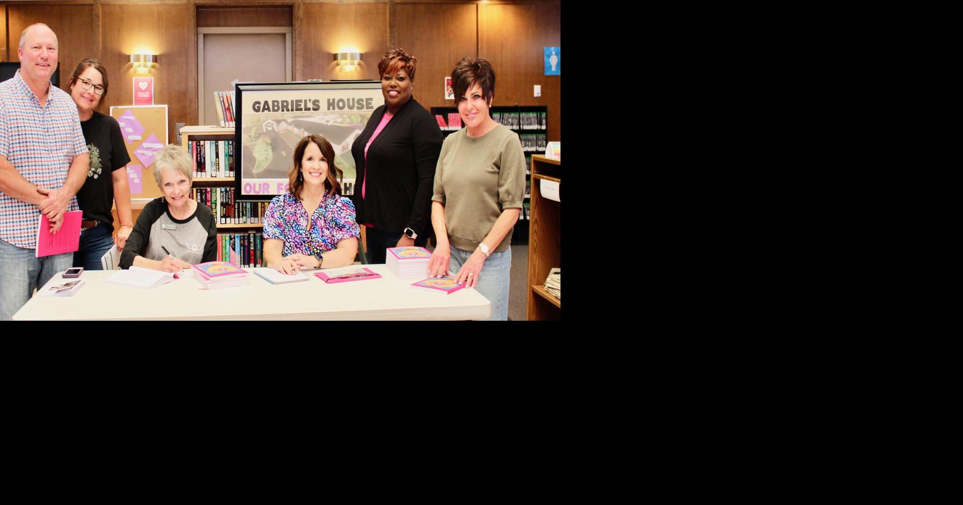 Photo Bonnie Talley signs books to benefit Gabriel’s House, Inc