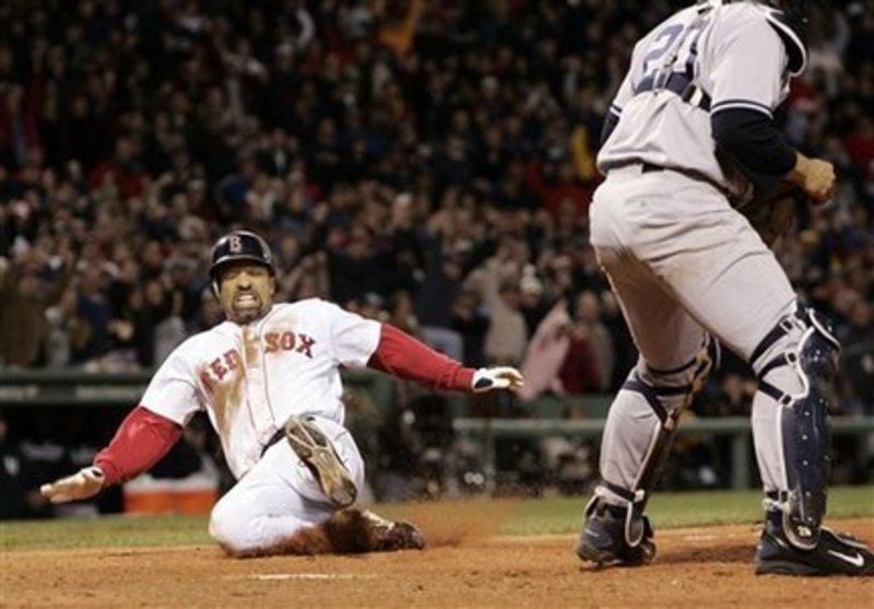 Boston Red Sox's Johnny Damon scores on a sacrifice fly by Manny