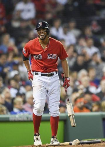 Xander Bogaerts of the Boston Red Sox warms up as he wears the