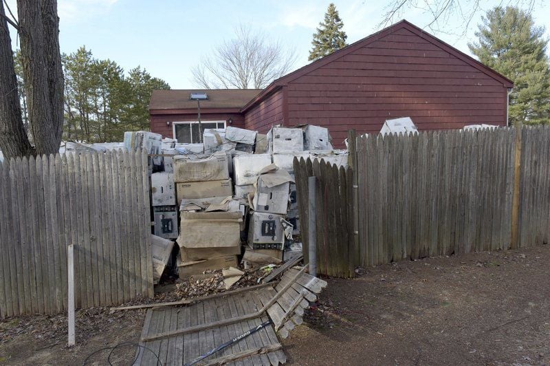 Backyard trash stacked five feet deep has Salem neighbors demanding