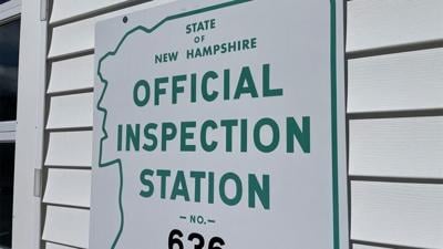 An old "Official Inspection Station" sign