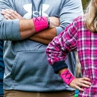 Protesters wear pink armbands