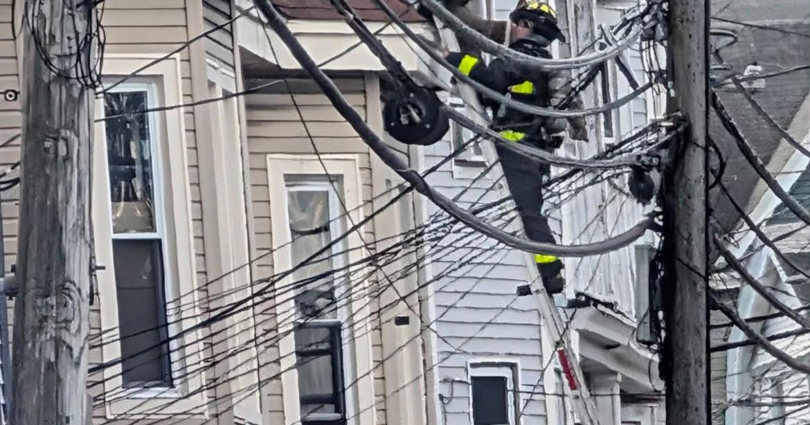 Man rescued from window as firefighters battle 5-alarm blaze in Lawrence