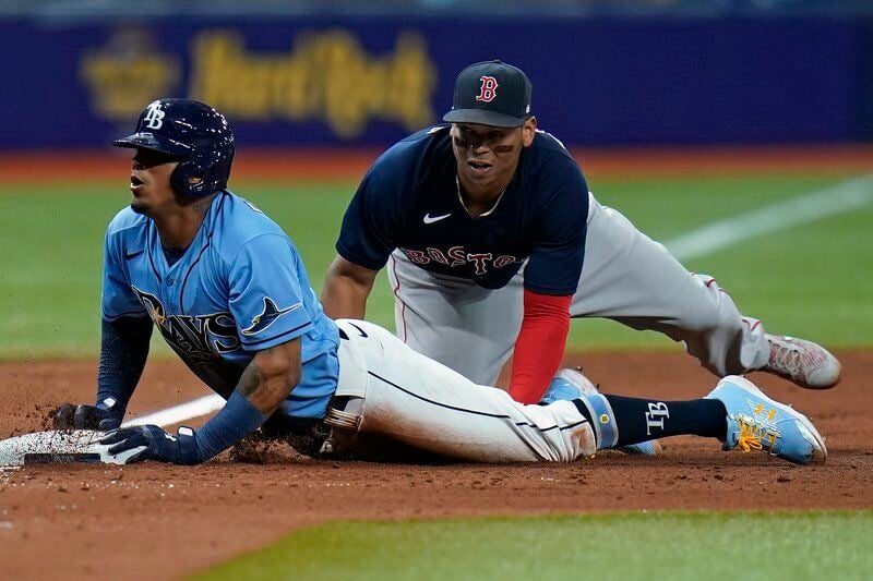 Tampa Bay Rays' Brandon Lowe throws his helmet after striking out