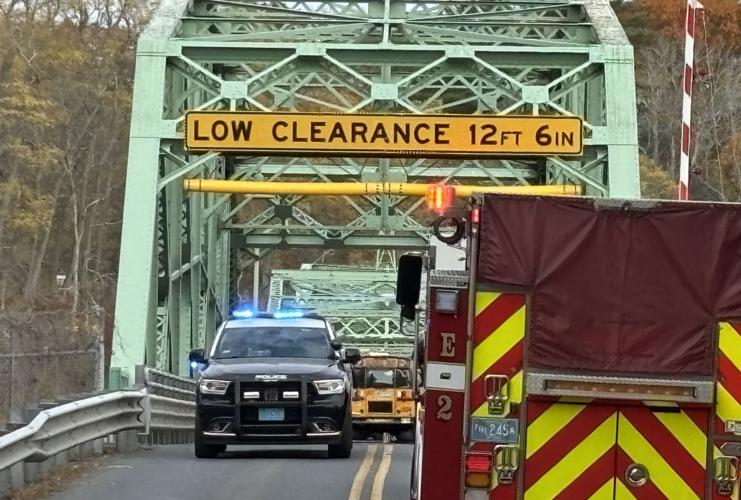 School bus stuck on bridge after crash Photos