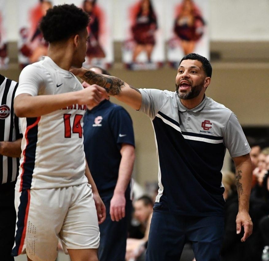 Boys in basketball uniforms receiving instruction from coach Free Photo  Download