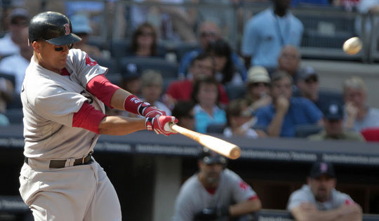 New York Yankees' Lance Berkman rips off his shirt during batting