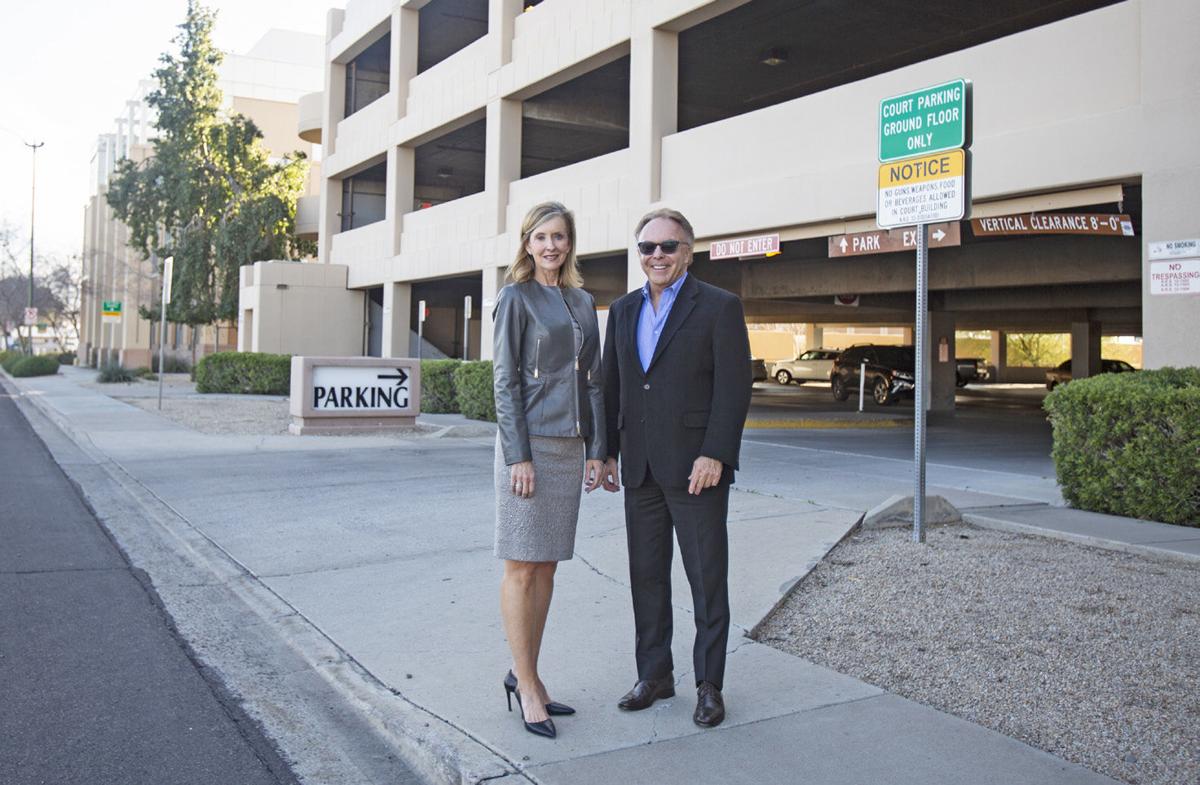 Taylor Robson and developer Tony Wall stand in front of the city garage that will become hidden behind a new veneer of three-story row houses near Main Street and Mesa Drive. (Pablo Robles/Tribune Staff Photographer)