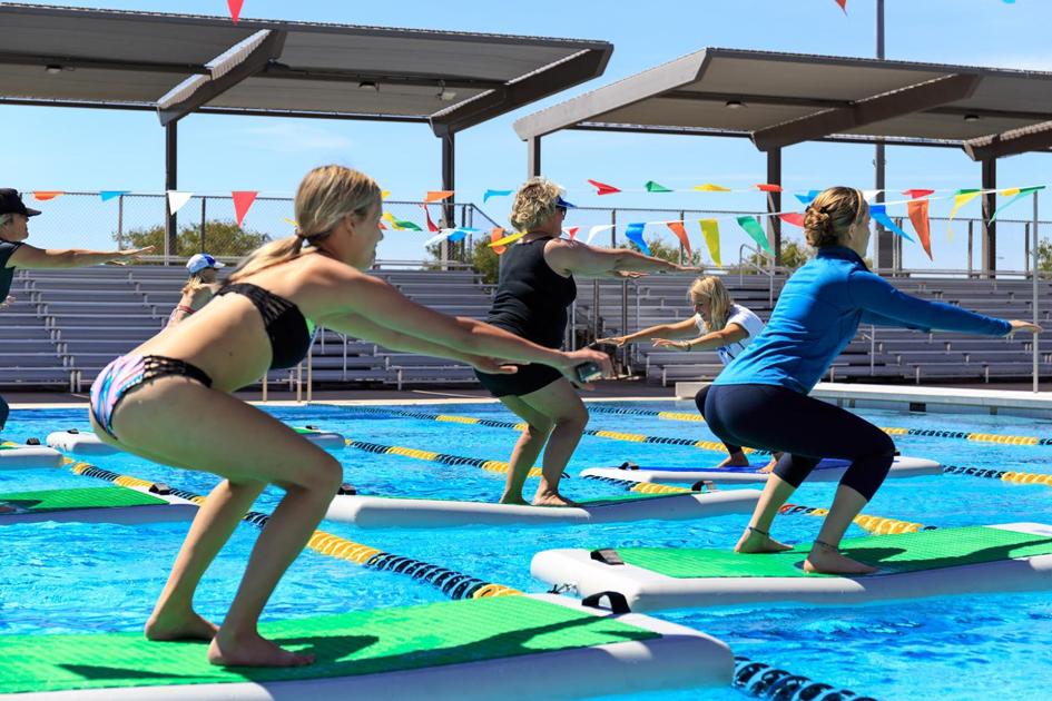 Paddleboard exercising blends yoga, flexibility and swimming pools Az