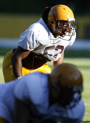 Arizona State linebacker Morris Wooten runs a football drill at