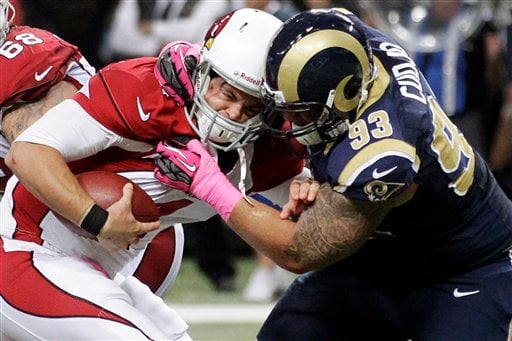 Arizona Cardinals quaterback Kurt Warner smiles on ths sidelines