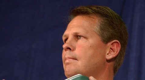 Danny Ainge holds up a Celtics jersey bearing his old number