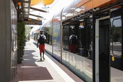 A lone passenger debarks at the light rail stop at Mesa Drive, currently the eastern end of the line. Valley Metro and Mesa officials hope to extend the light rail to Gilbert Road.